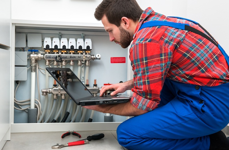 Technician checking the pipes' diagnostics at work
