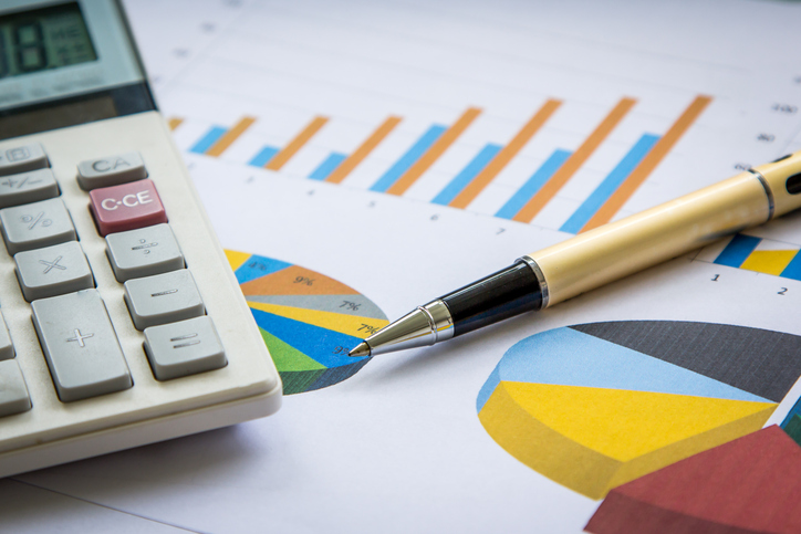 Business concept, Pen and calculator on graph background
